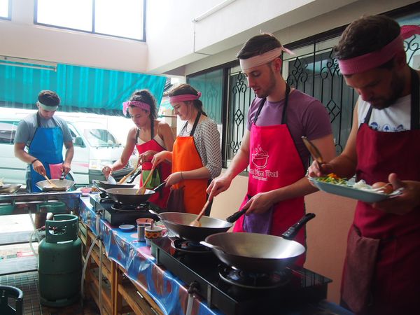 Smiling travelers cooking